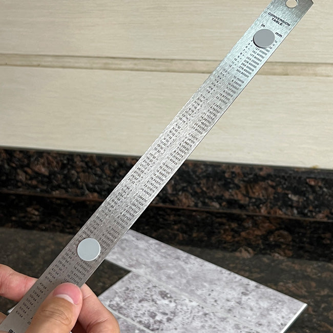 Applying anti-slip cutting grips to the back of a metal ruler for peel and stick tile cutting
