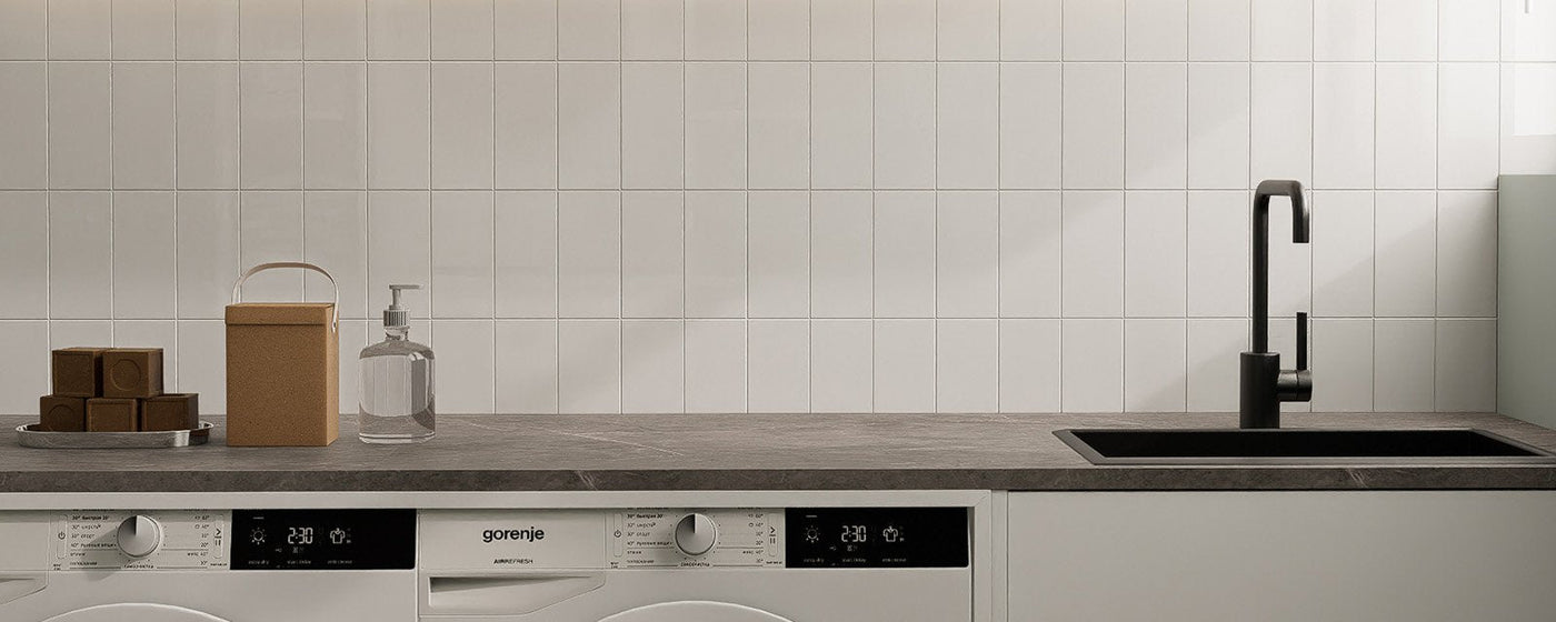 Bright laundry room with white peel and stick backsplash behind the appliances