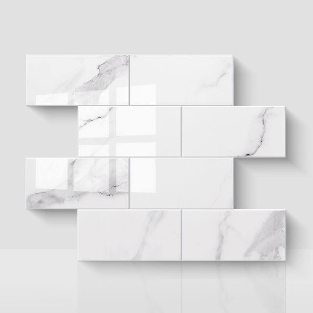 Glossy Carrara white subway peel and stick backsplash tiles in a staggered layout