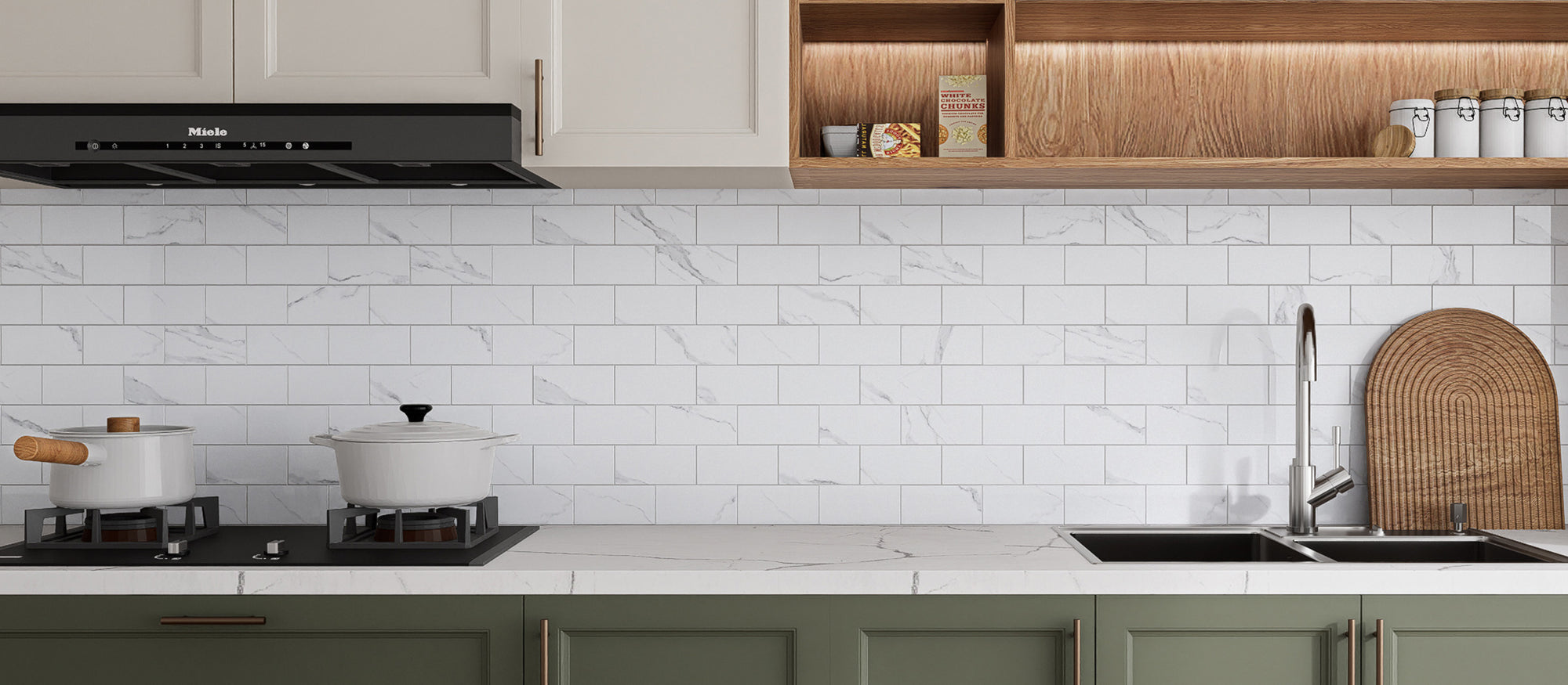 Glossy Carrara White peel and stick backsplash tiles installed behind a kitchen sink after installation