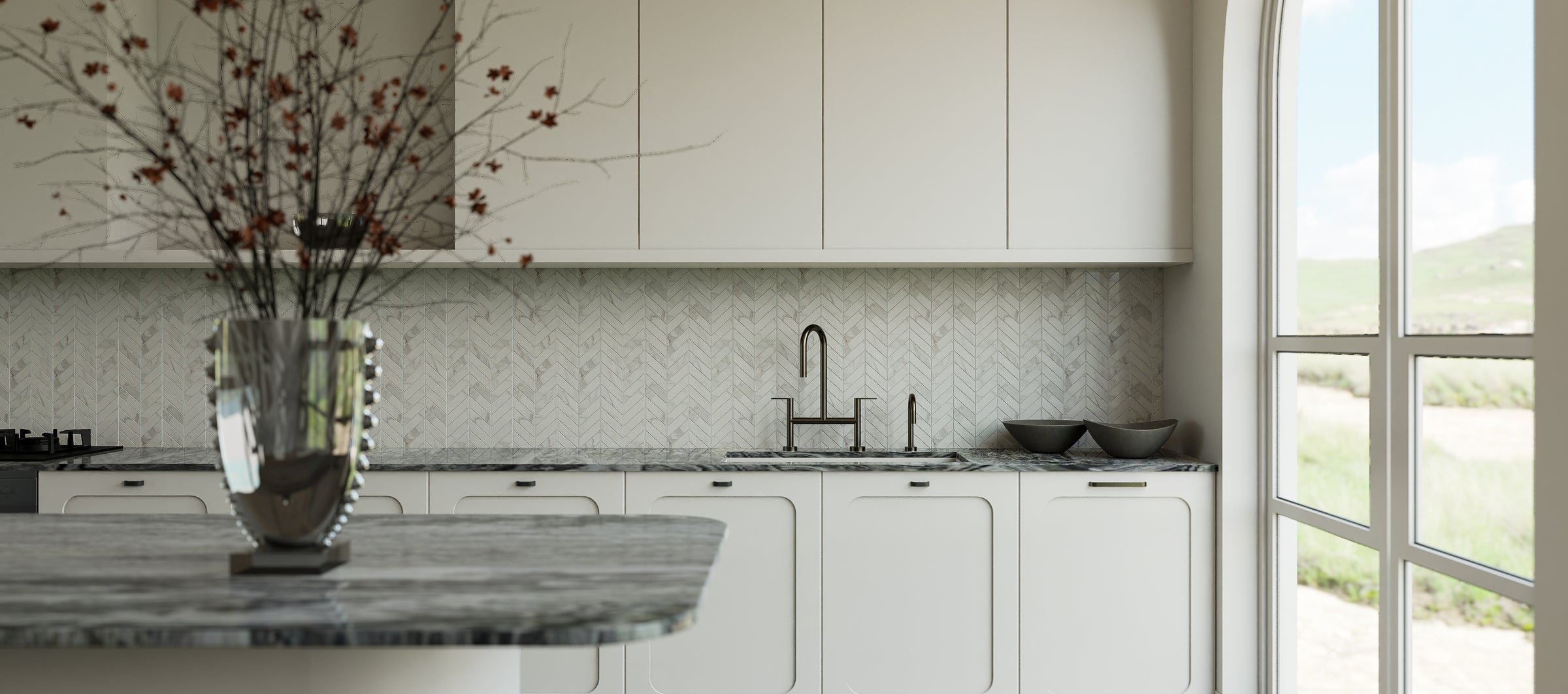 Modern kitchen with white cabinets, marble countertop, and large window.