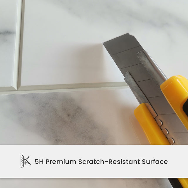 Utility knife on Carrara white tile showing scratch-resistant surface