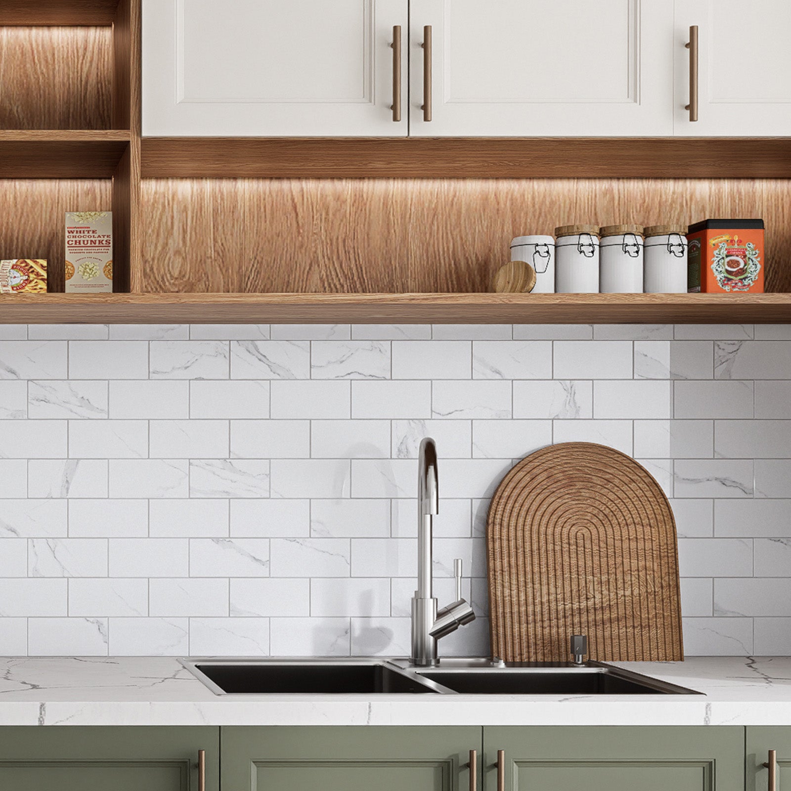 Glossy Carrara White peel and stick backsplash tiles installed behind a modern kitchen sink