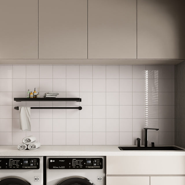 Glossy Pure White square peel and stick backsplash tiles used on a clean laundry room wall