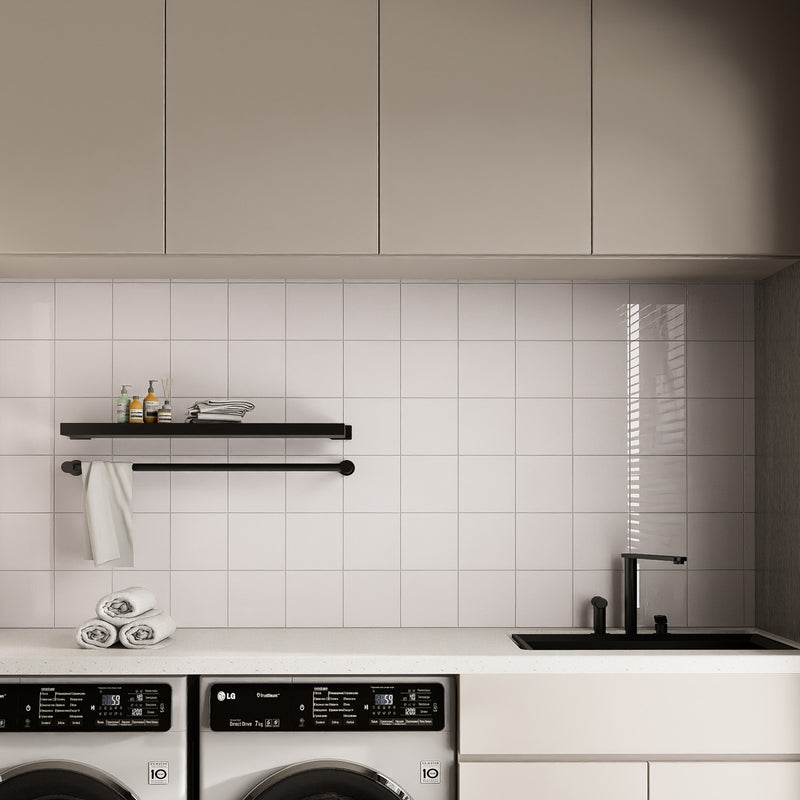 Glossy Pure White square peel and stick backsplash tiles used on a clean laundry room wall