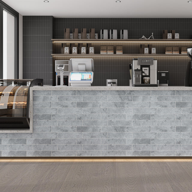 Matte Urban Concrete subway peel and stick tiles installed on a modern commercial counter front