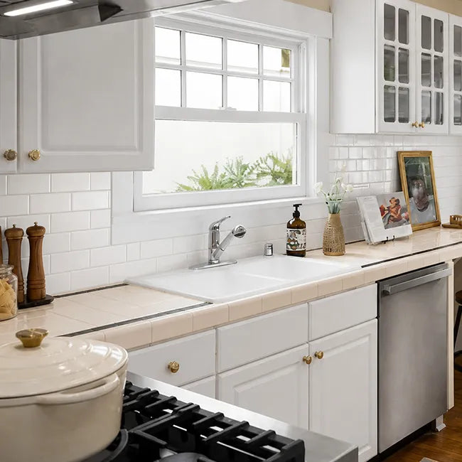 White glossy peel and stick subway tile backsplash in bright farmhouse kitchen